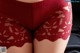 A close up of a woman's butt in a red panties.