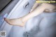 A woman's legs in a bathtub filled with foam.