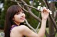 A woman holding a white flower in her hand.