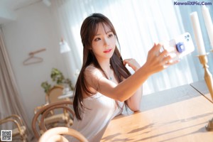 A woman taking a picture of herself with a cell phone.