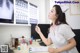 A woman sitting at a desk in front of a computer.