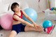 A young girl sitting on the floor with her legs crossed.